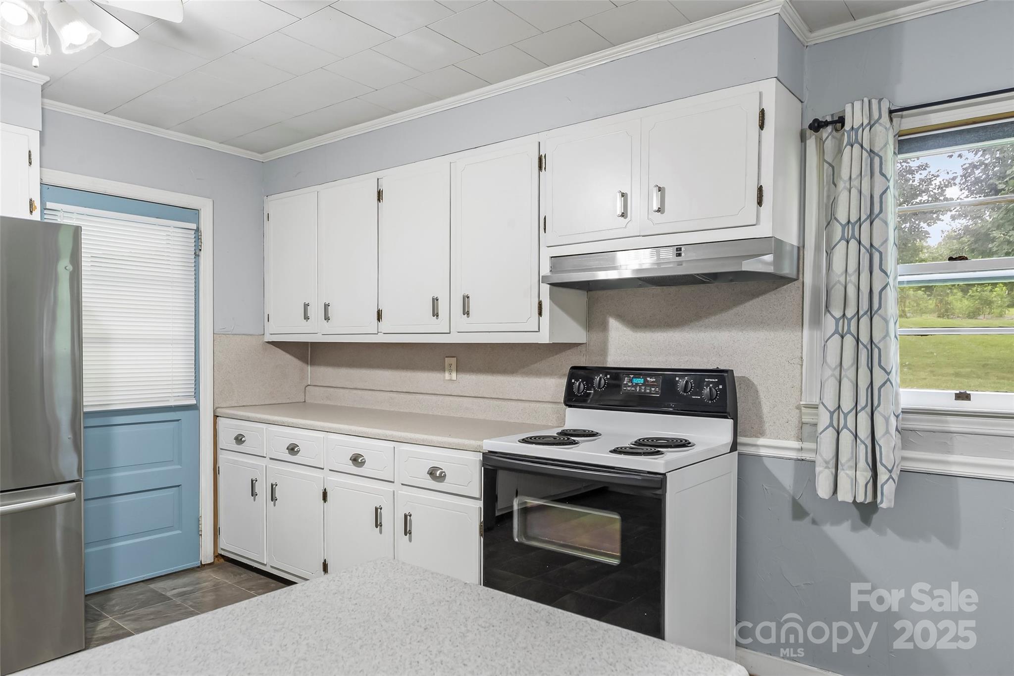 2777 Pax Hill Road Morganton, NC 28655 - Photo 10 of 33 a kitchen with cabinets appliances and a wooden floor
