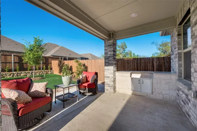 a view of a patio with couches chairs and potted plants