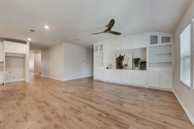 a view of a livingroom with wooden floor and a window