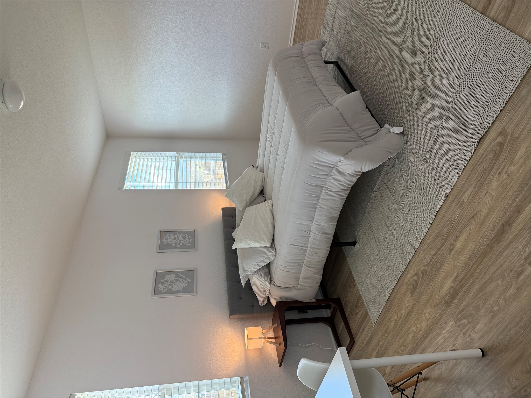 14907 Retha Pass Austin, TX 78725 - Photo 13 of 22 Well-lit sleeping quarters with rich hardwood flooring and convenient desk space.