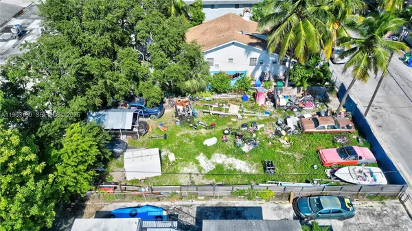 an aerial view of a house with a yard fountain and a large tree