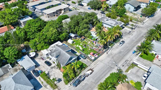 an aerial view of a house with a yard and garden