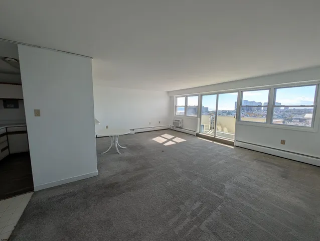 an empty room with floor to ceiling windows