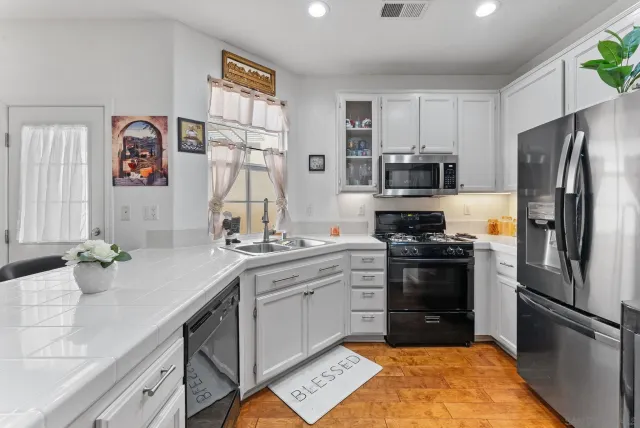 a kitchen with a sink stove and refrigerator