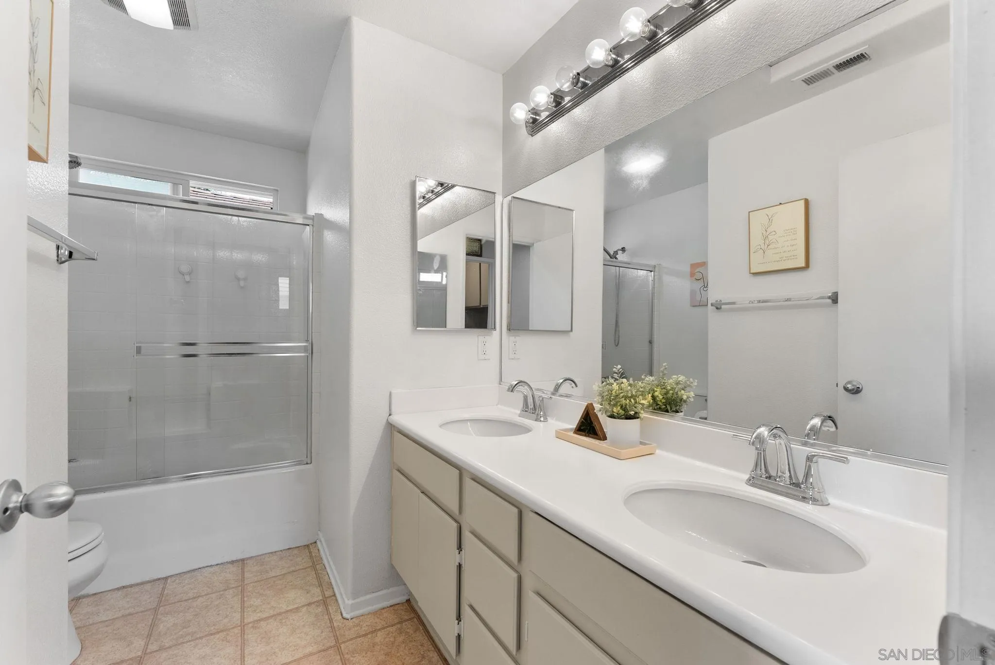 1924 Geyserville Street Chula Vista, CA 91913 - Photo 17 of 37 a bathroom with a shower sink and mirror
