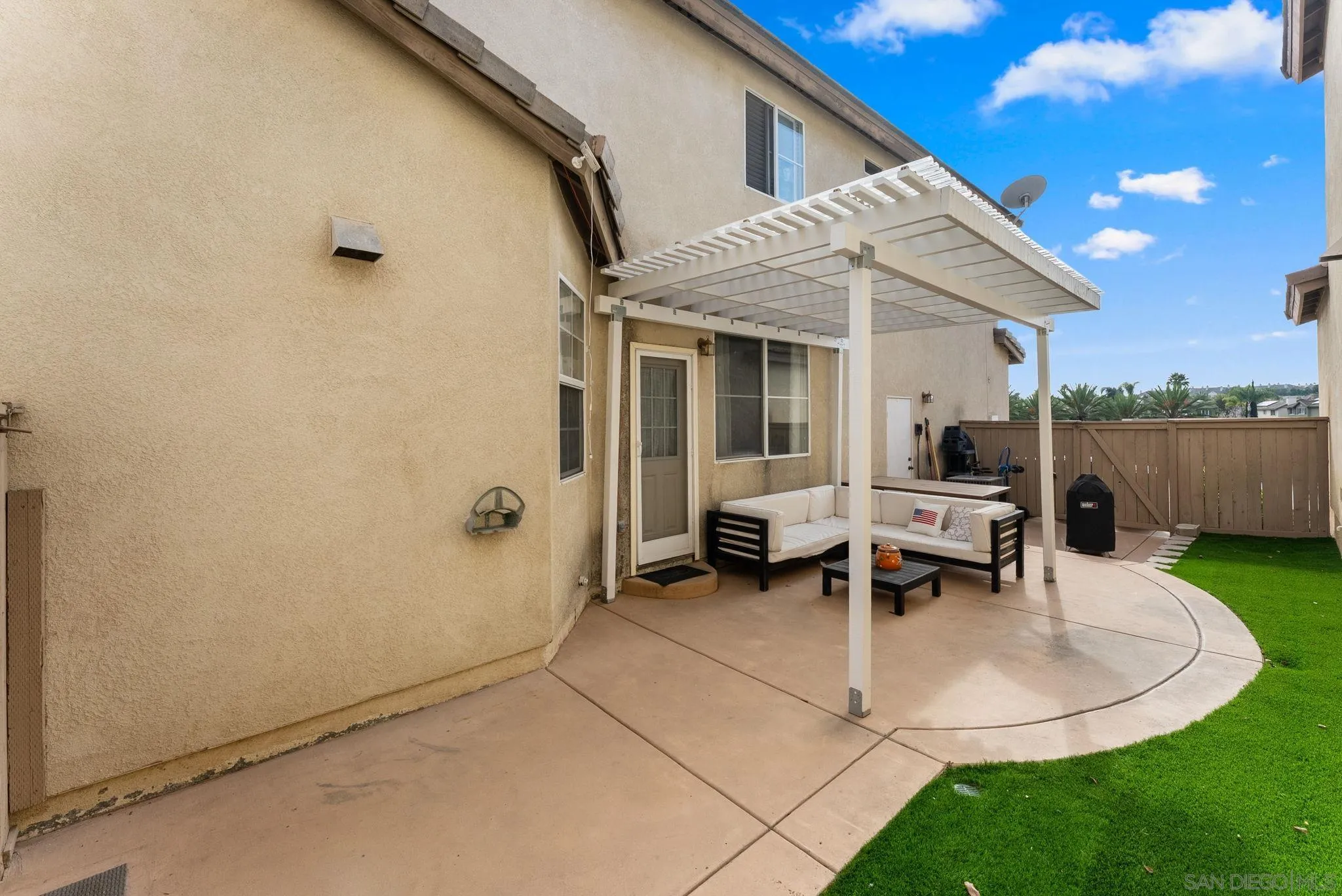 1924 Geyserville Street Chula Vista, CA 91913 - Photo 27 of 37 a view of a patio with table and chairs with wooden fence and plants