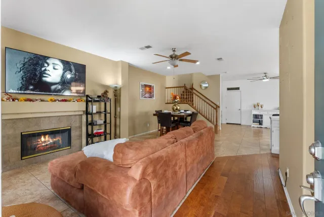 a living room with furniture a fireplace and a flat screen tv