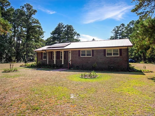 a view of a house with swimming pool and a yard