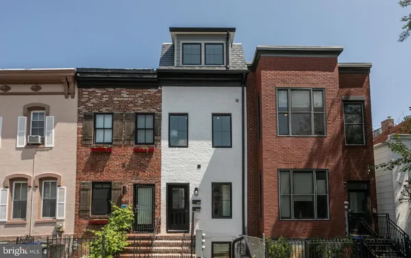 a front view of a residential apartment building with a yard