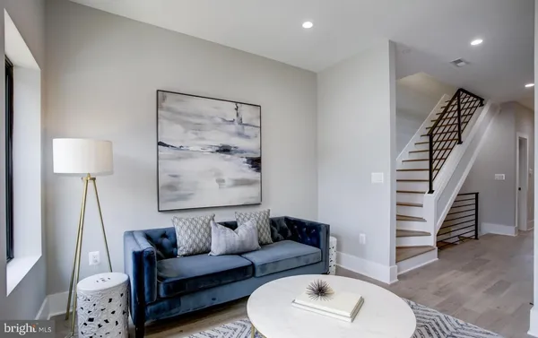 a living room with furniture and a lamp