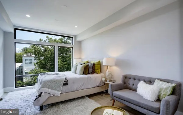 a bedroom with a bed and glass window