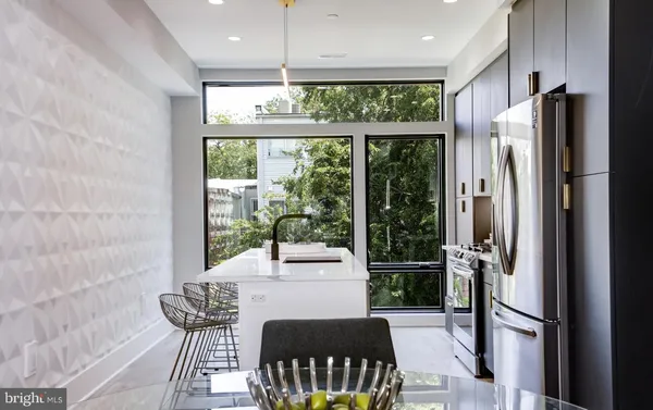 a kitchen with a table chairs refrigerator and furniture