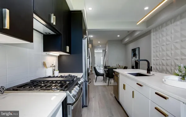 a kitchen with a sink stove and cabinets