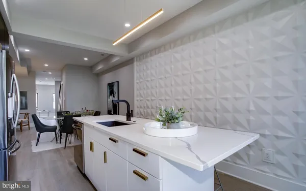 a kitchen with a sink a table and chairs