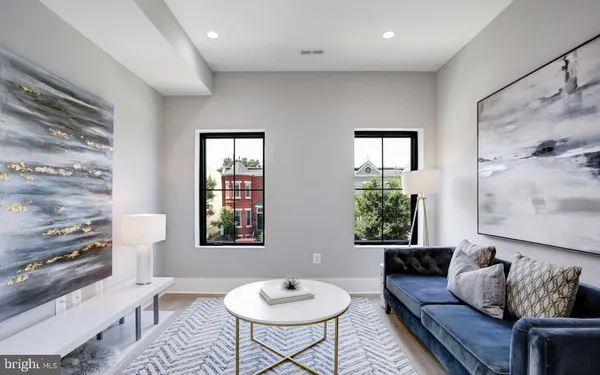 a living room with furniture and a painting
