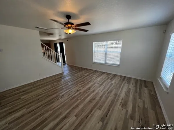 wooden floor in an empty room with a window