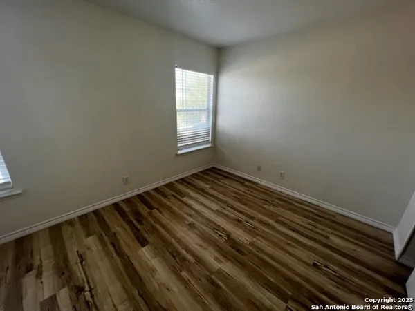 a view of a room with wooden floor