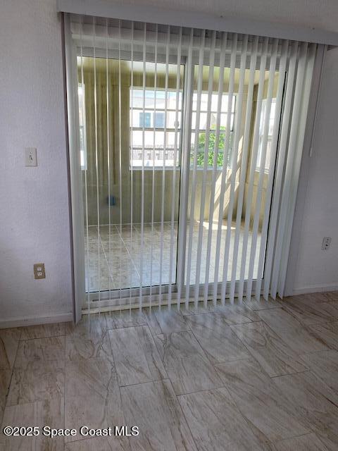 907 Espanola Way Melbourne, FL 32901 - Photo 6 of 7 an empty room with wooden floor and windows