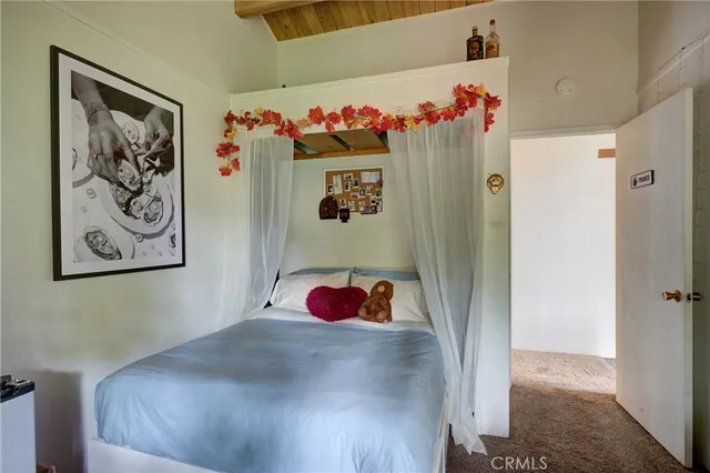 a backyard of a house with table and chairs plants and large trees