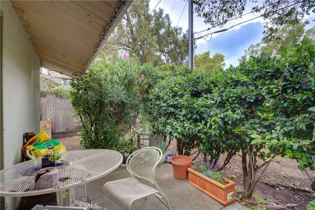 a view of a house with large windows and a large tree