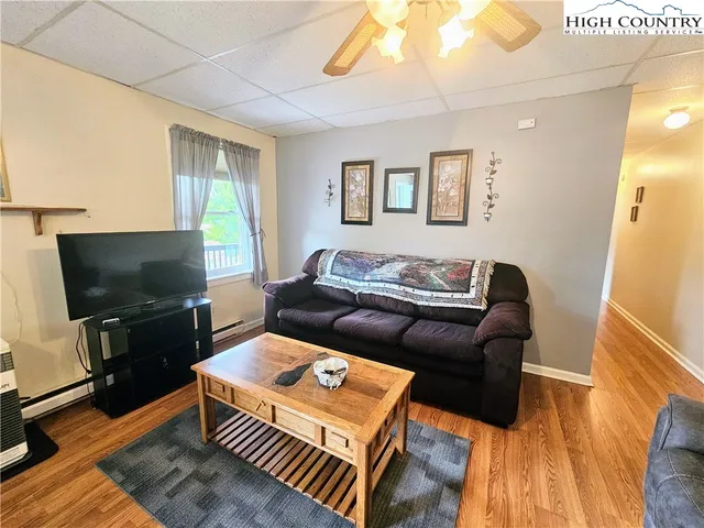 a living room with furniture and a flat screen tv
