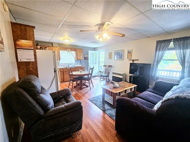a living room with furniture fireplace and a large window