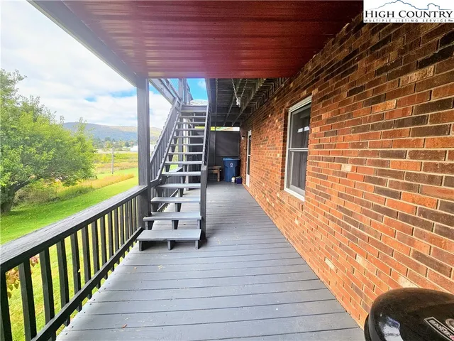 a view of a balcony with wooden floor