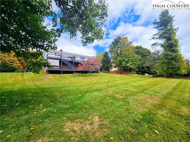 a backyard of a house with yard and trampoline