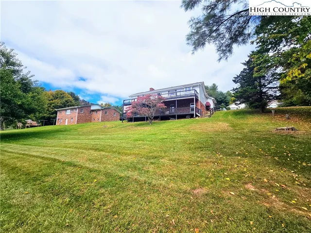 a view of a house with a yard and sitting area