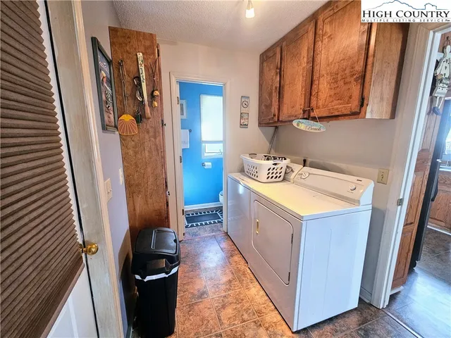 a utility room with sink dryer and washer