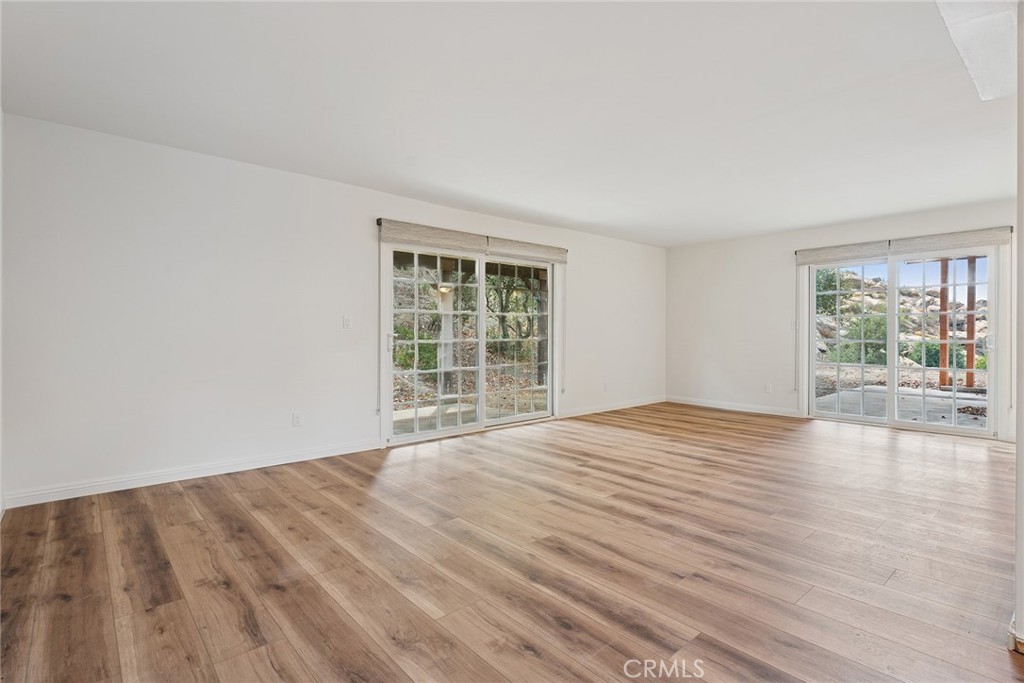 7254 Studio Road Canoga Park, CA 91304 - Photo 16 of 26 a view of an empty room with wooden floor and a window