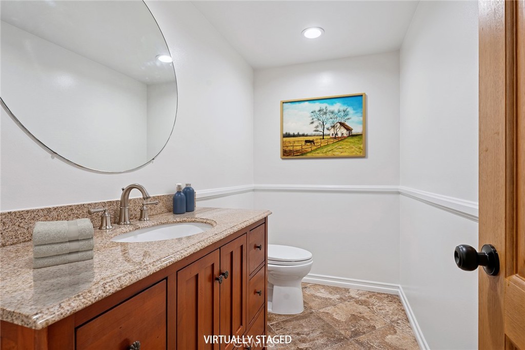 7254 Studio Road Canoga Park, CA 91304 - Photo 3 of 26 a bathroom with a granite countertop sink and a mirror