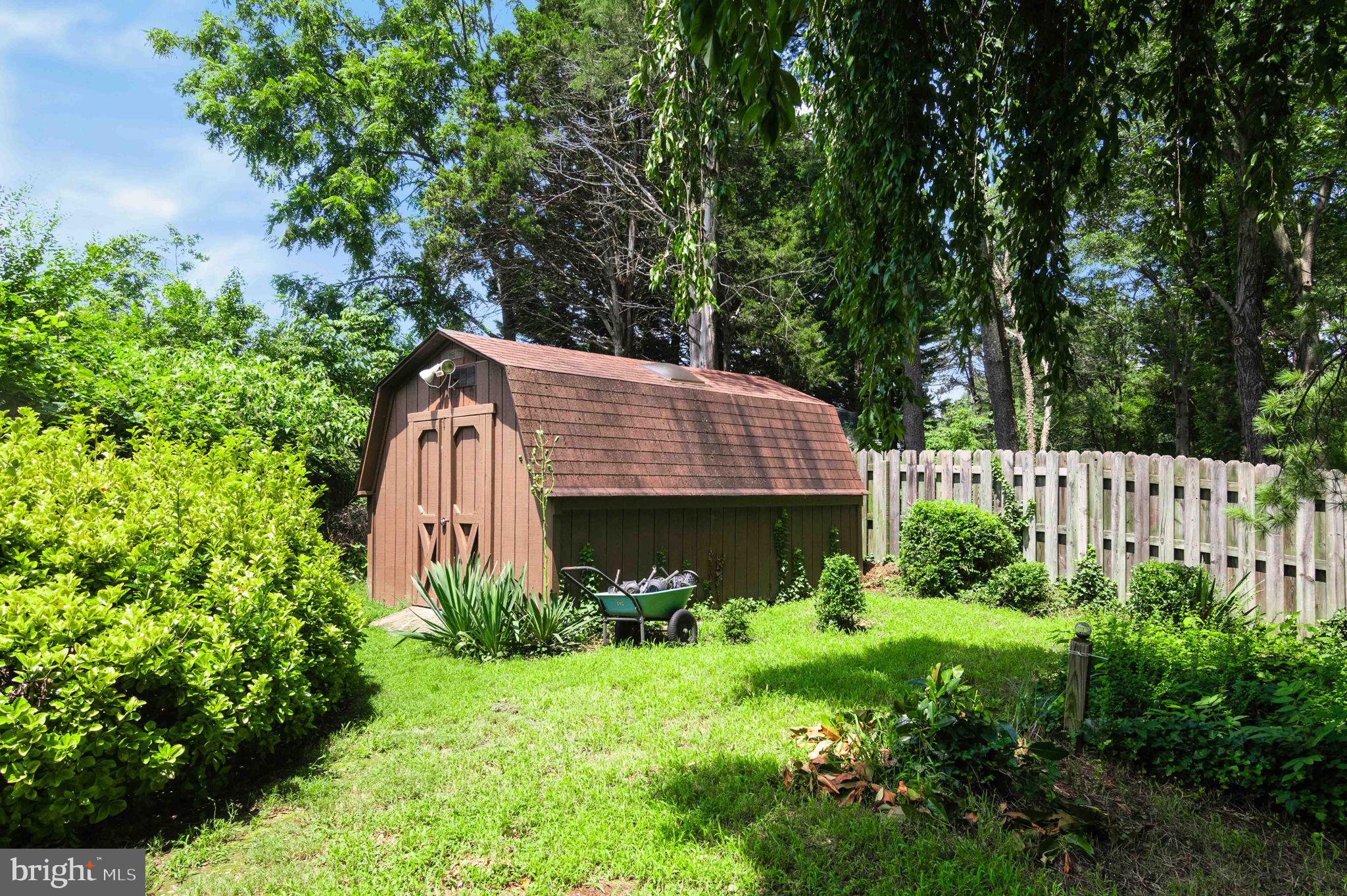 10404 Amherst Circle Fredericksburg, VA 22408 - Photo 11 of 74 a view of a house with a small yard plants and large trees