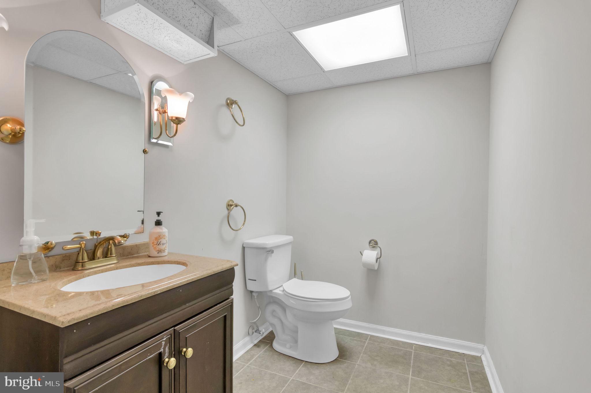 10404 Amherst Circle Fredericksburg, VA 22408 - Photo 13 of 74 a bathroom with a granite countertop sink toilet and a mirror