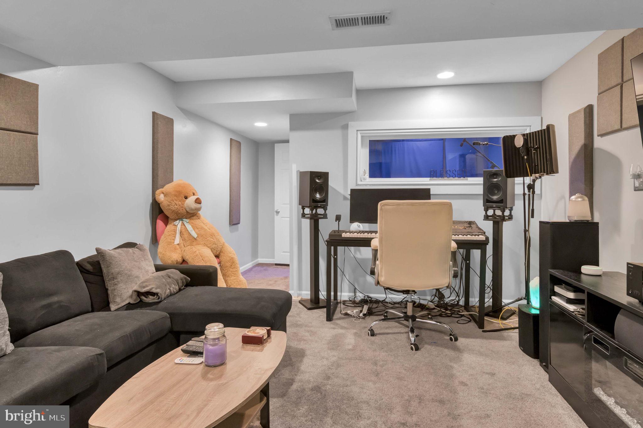 10404 Amherst Circle Fredericksburg, VA 22408 - Photo 15 of 74 a living room with furniture a flat screen tv a rug and a refrigerator