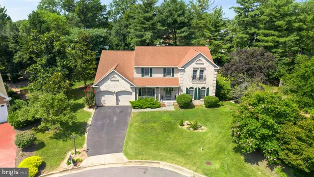 an aerial view of a house with a yard and trees
