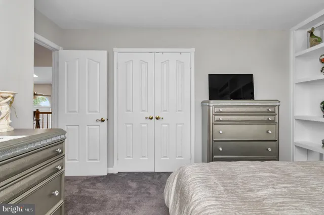 a view of a livingroom with furniture wooden floor chandelier fan and windows