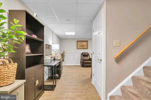 a kitchen with stainless steel appliances granite countertop a stove a sink dishwasher a dining table and chairs with wooden floor