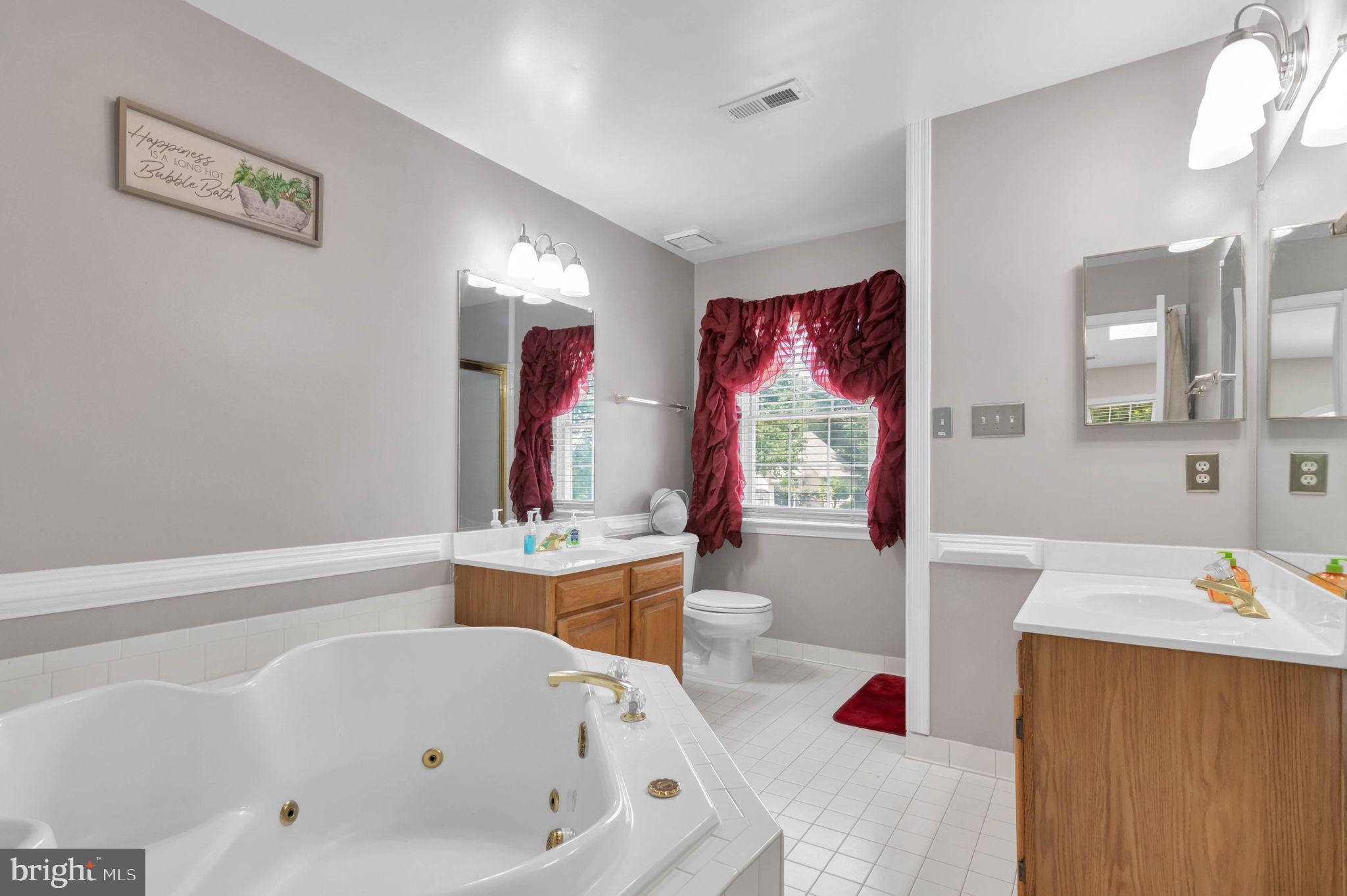 10404 Amherst Circle Fredericksburg, VA 22408 - Photo 35 of 74 a bathroom with a tub sink and a mirror
