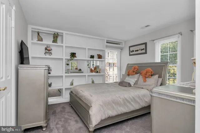 a living room with furniture and a dining table with wooden floor