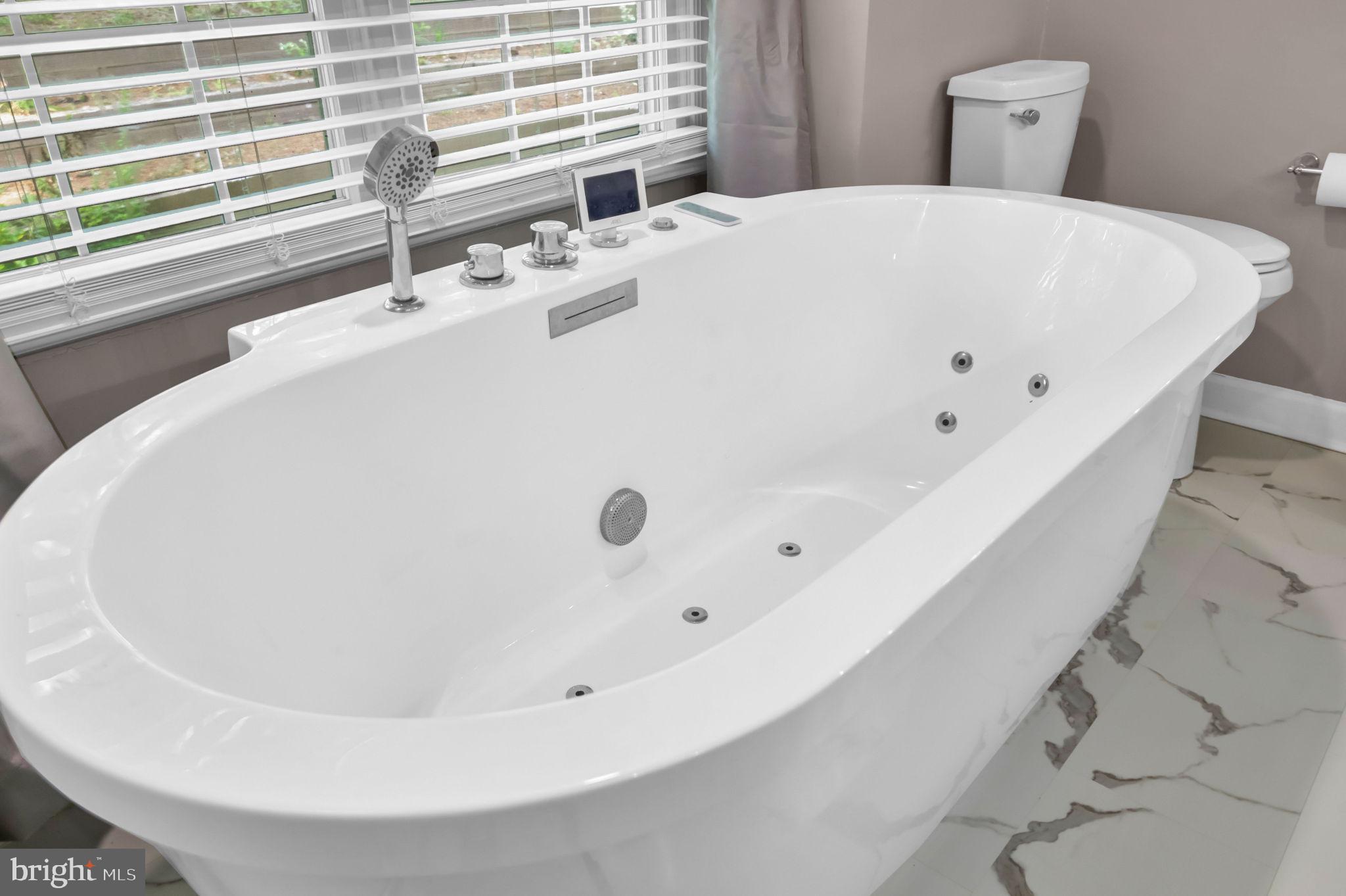 10404 Amherst Circle Fredericksburg, VA 22408 - Photo 41 of 74 a white bath tub sitting in a bathroom