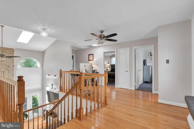 a living room with furniture a wooden floor and a kitchen view
