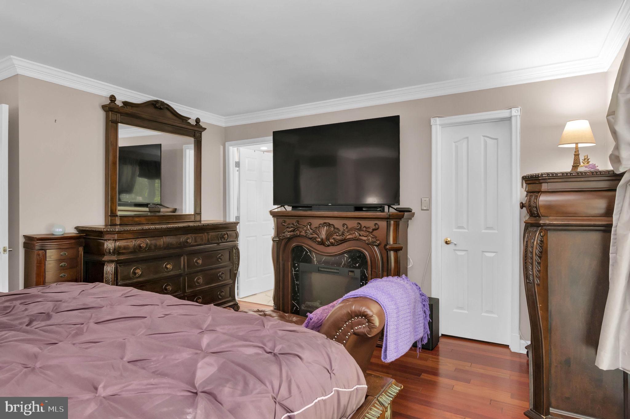 10404 Amherst Circle Fredericksburg, VA 22408 - Photo 49 of 74 a bedroom with a bed and a flat screen tv