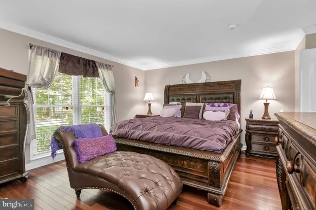 a view of white house with a yard and potted plants