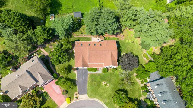 a front view of a house with a yard and potted plants