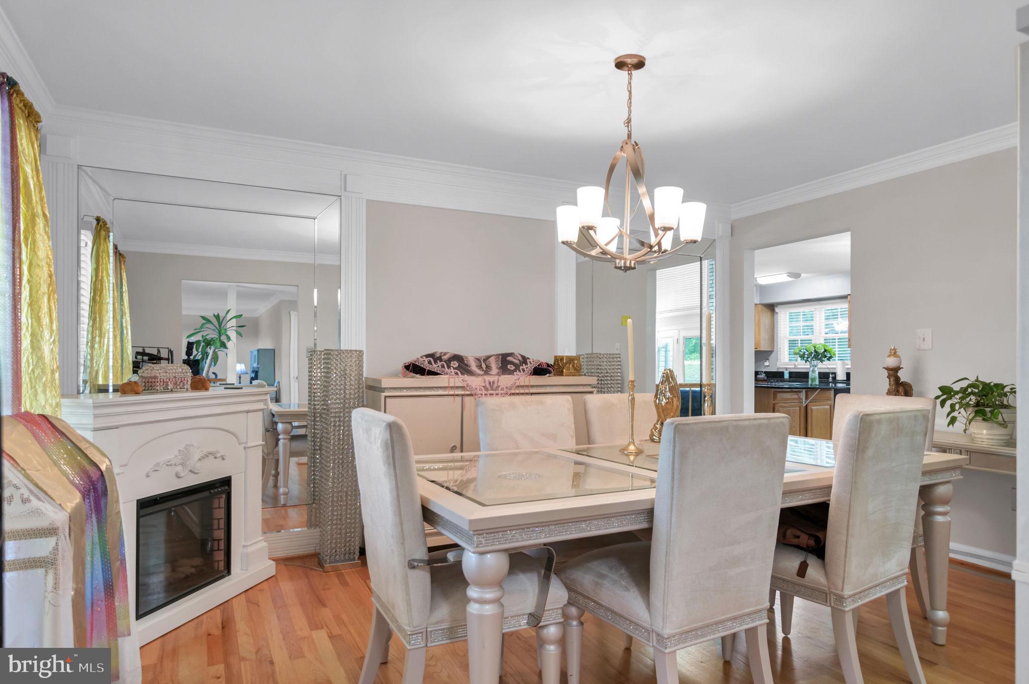 10404 Amherst Circle Fredericksburg, VA 22408 - Photo 61 of 74 a view of a dining room with furniture a chandelier and wooden floor