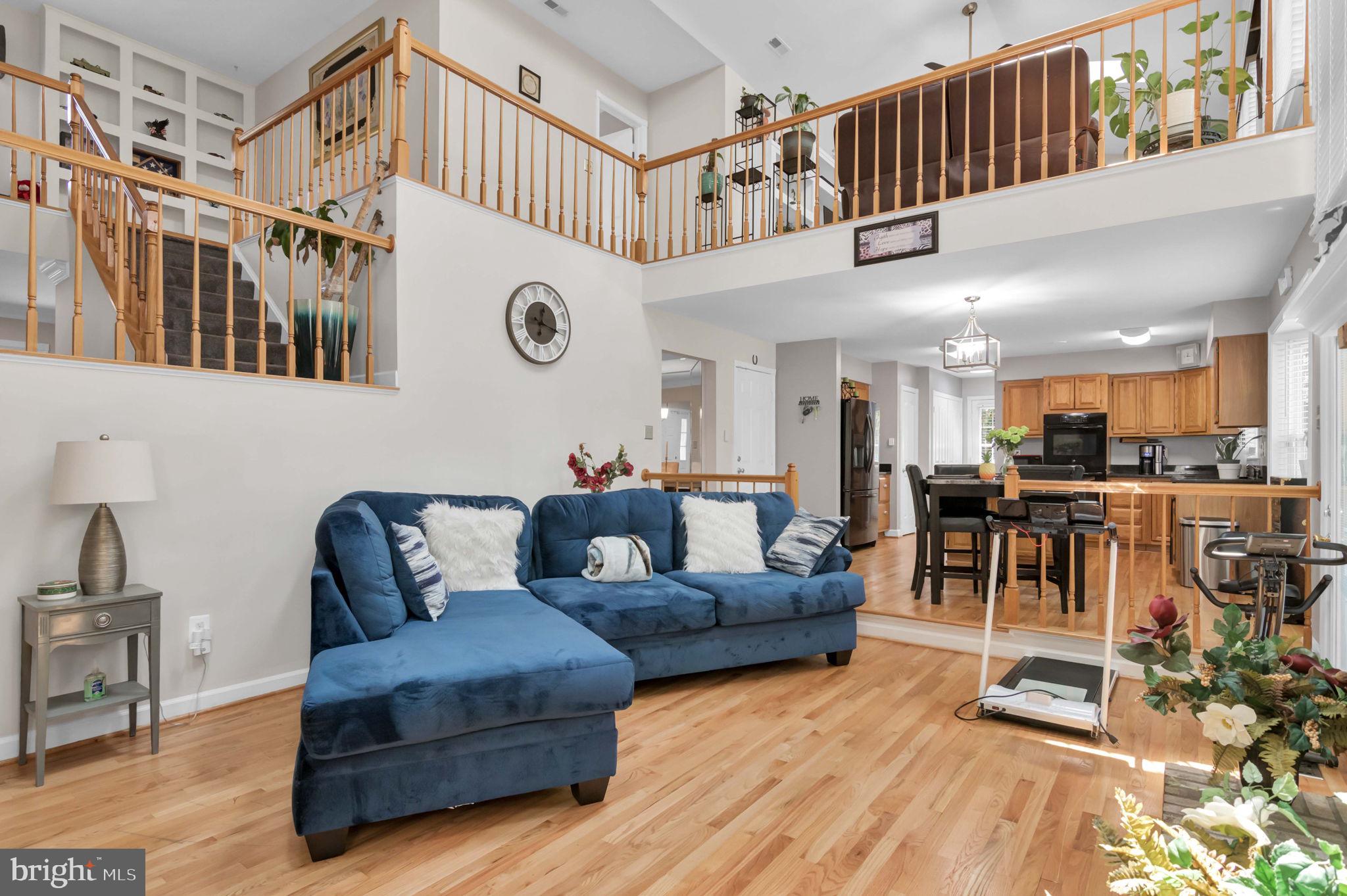 10404 Amherst Circle Fredericksburg, VA 22408 - Photo 67 of 74 a living room with furniture a wooden floor and a kitchen view