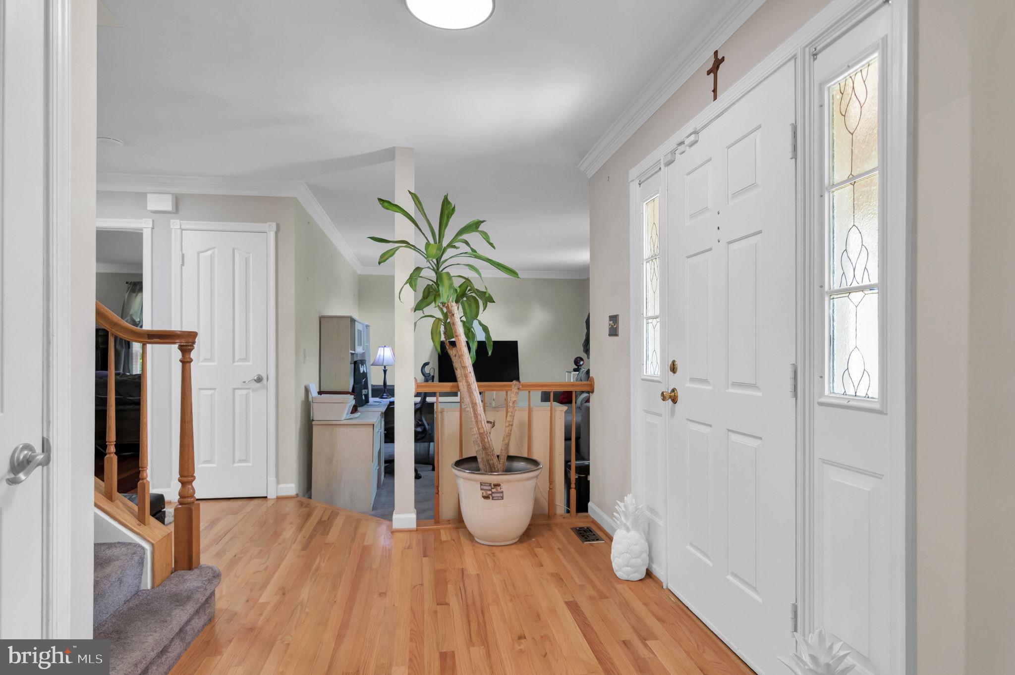 10404 Amherst Circle Fredericksburg, VA 22408 - Photo 70 of 74 a view of a hallway with wooden floor and chandelier