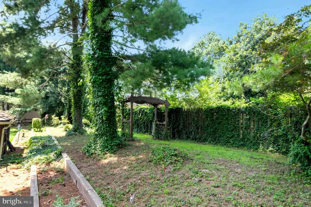 a bathroom with a granite countertop sink toilet and a mirror