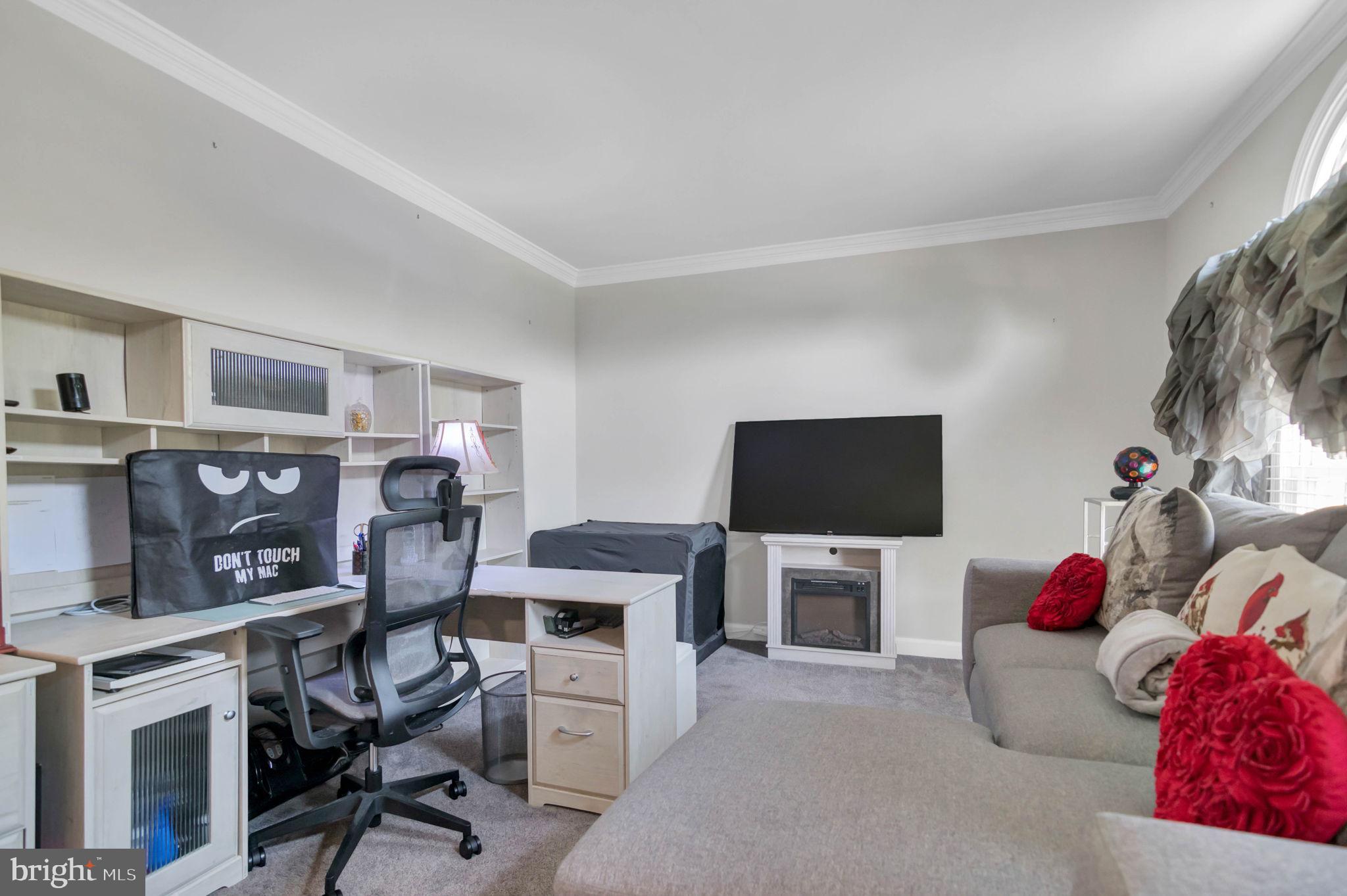 10404 Amherst Circle Fredericksburg, VA 22408 - Photo 72 of 74 a living room with furniture a flat screen tv and a fireplace